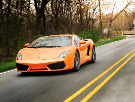 Orange Lamborghini On Road During Day Time