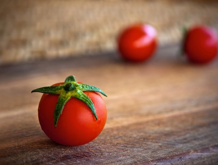 3 Red Cherry Tomato On Wooden Plank