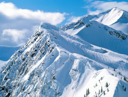 Mountain Covered With Snow Under Blue Sky And White Clouds During Daytime