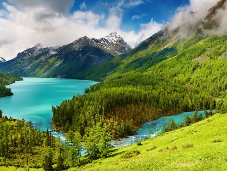 White Clouds Behind Mountain Beside Water And Forest During Daytime