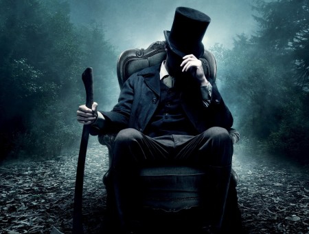 Man In Black Suit Jacket Sitting On Black Chair