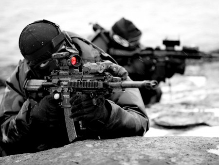 Man Wearing Black Suits On Sniper Gun