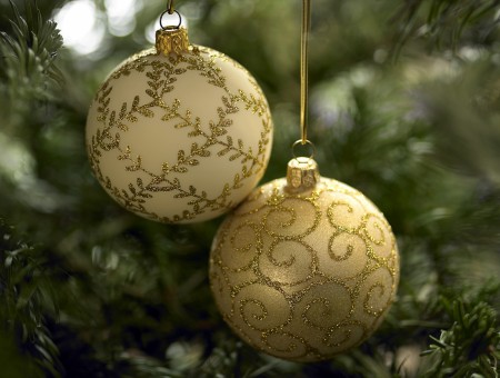 Two gold glittered baubles