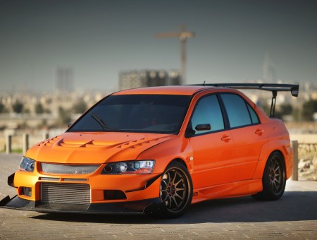 Orange Mitsubishi on road
