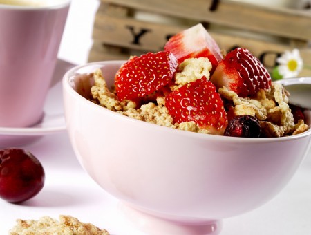 A bowl of cereal with strawberries