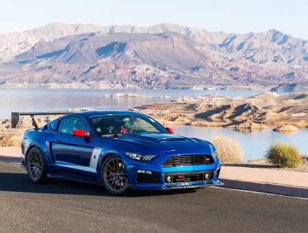 Blue Ford Mustang and mountains