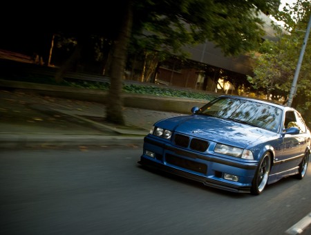 Blue BMW E36 on road