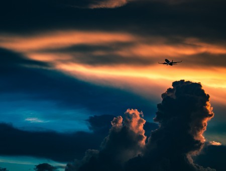 The plane flies over the dark clouds
