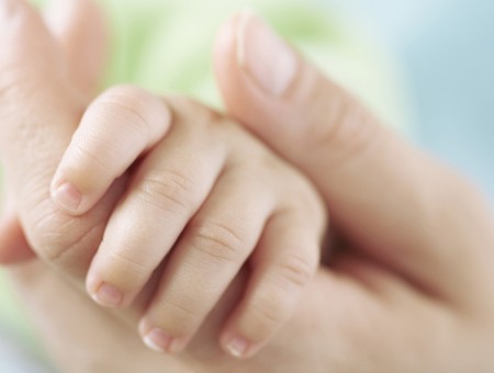 Hand of mother and small child
