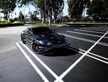 Black Aston Martin on parcking zone