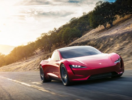 Red electric car Tesla Roadster 2020 on the road