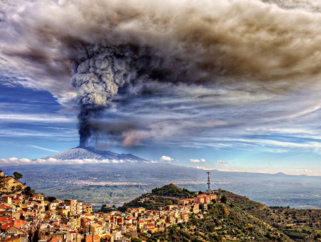 Volcano eruption above city