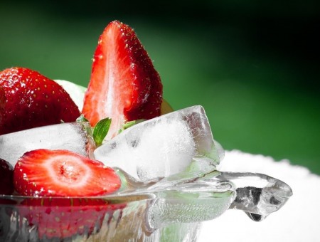 strawberry and ice and water in glass