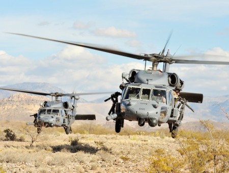 two helicopters above desert