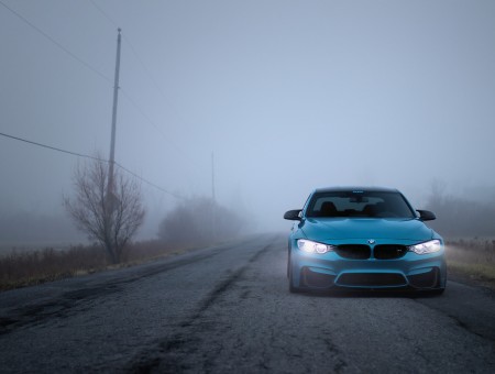 Blue bmw on fog road