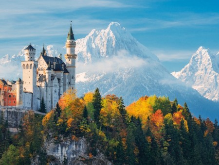 Castle in autumn forest on mountains