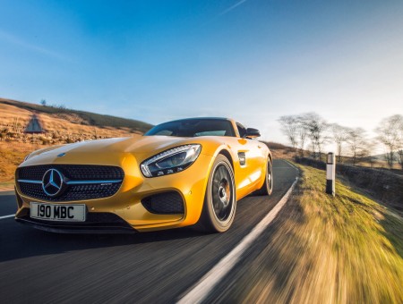 Yellow mercedes on road