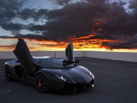 Black Lamborghini on sunset background