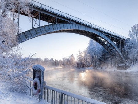 Winter bridge above river