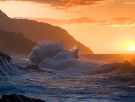 Sea waves on sunset background