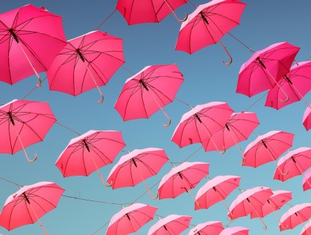 pink umbrellas flying